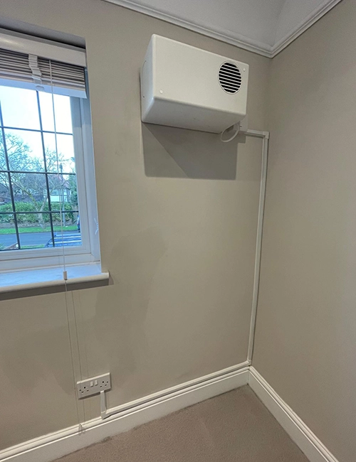 PIV unit secured to a freshly decorated wall after mould treatment.